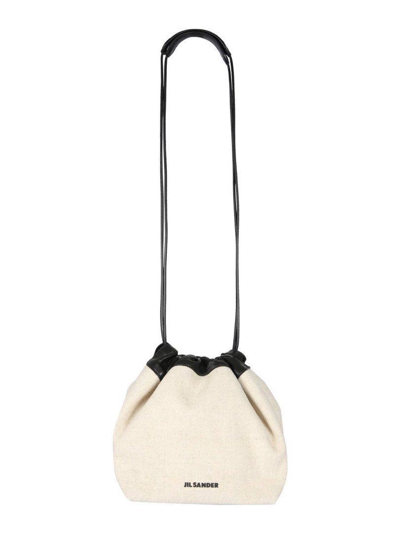 Jil Sander Canvas Drawstring Bucket Bag (Category: Luxury Bags & Wallets) located in Taguig. Submitted by mariow (Listing ID 1410025959, Image 3). Description: Thrifted, source unknown Can be reversible if you want it - Jil Sander drawstring bag - Cream canvas body - Black leather trim - Long, thin strap (shoulder/crossbody) - Jil Sander logo on front - Interior pocket Quiet Luxury.