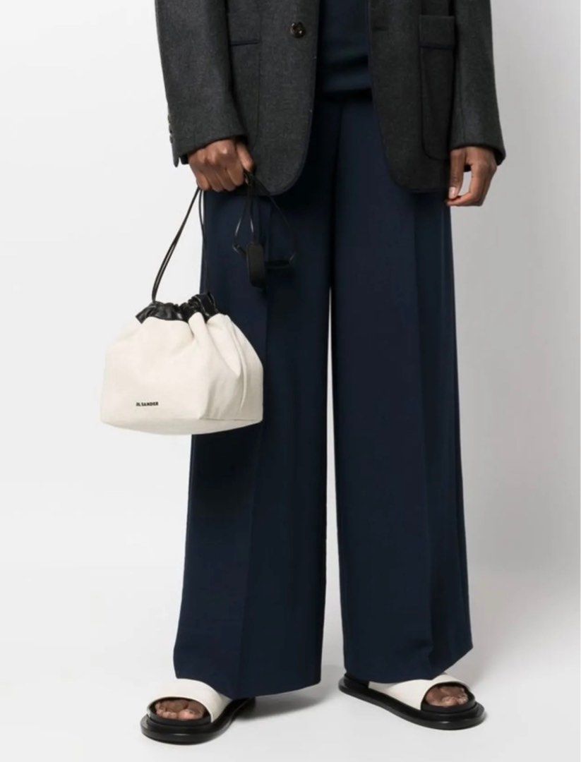 Jil Sander Canvas Drawstring Bucket Bag (Category: Luxury Bags & Wallets) located in Taguig. Submitted by mariow (Listing ID 1410025959, Image 1). Description: Thrifted, source unknown Can be reversible if you want it - Jil Sander drawstring bag - Cream canvas body - Black leather trim - Long, thin strap (shoulder/crossbody) - Jil Sander logo on front - Interior pocket Quiet Luxury.
