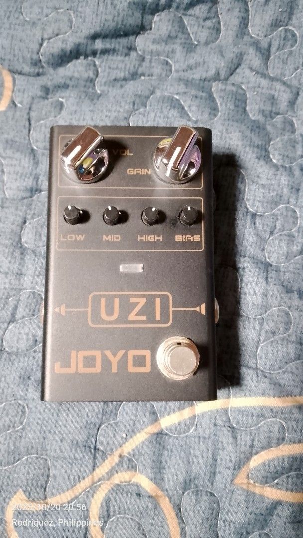 JOYO UZI Distortion Guitar Pedal (Category: Musical Instruments) located in Quezon City. Submitted by vastwhale_d30e56 (Listing ID 1410010702, Image 1). Description: JOYO UZI distortion guitar pedal. Features gain, volume, and tone controls (Low, Mid, High, Bias). Includes input and output jacks, and a DC 9V power input. The pedal has a footswitch for activation and a sync switch on the back. Made in China..