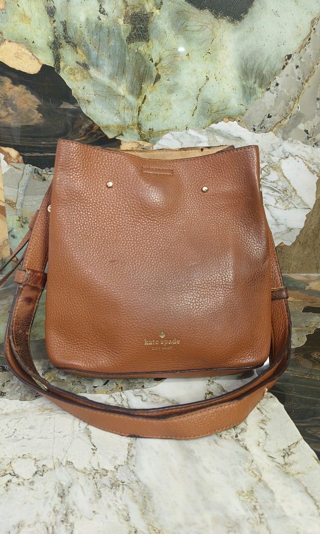 Kate Spade Marti Bucket Bag (Category: Luxury Bags & Wallets) located in Baguio. Submitted by PreiLoveMaria (Listing ID 1410149701, Image 2). Description: Kate Spade Marti Bucket bag Good used condition Signs of wear Size: 10.62"h x9.84"w x 5.9"d Handle drop: 19.5" Pebbled leather foil embossed Kindly check the Detailed photos Shipping via J&T only No COD and COP.