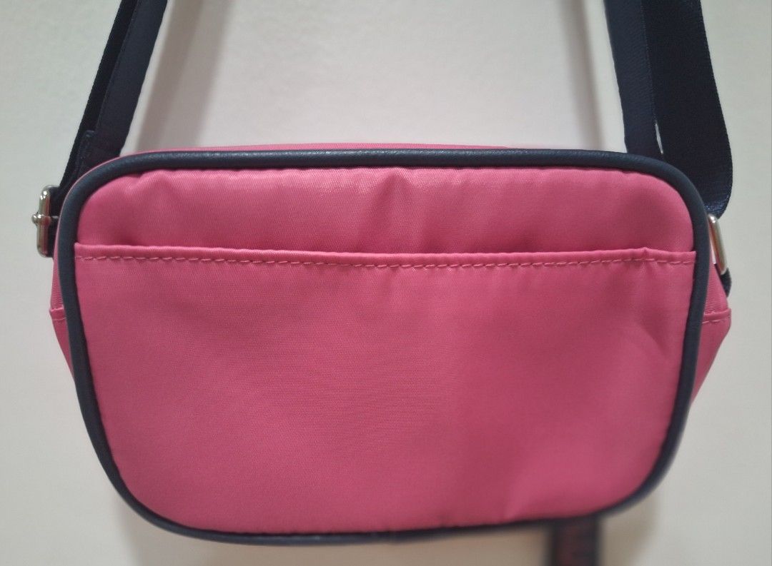 Nautica Pink Crossbody Bag (Category: Cross-body Bags) located in Quezon City. Submitted by thriftforkeeps (Listing ID 1410091349, Image 3). Description: - Nautica crossbody bag - Vibrant pink exterior - Navy blue strap - Zippered main compartment - Small back pocket - Nautica branded strap detail - Nautica logo on front - Light blue interior - Compact size - Ideal for everyday use.