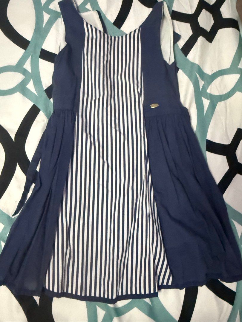 Navy Blue Striped Dress (Category: Babies & Kids Fashion) located in Bacoor. Submitted by rizza_455 (Listing ID 1410095609, Image 1). Description: Elle brand - Navy blue dress - Striped front panel - Solid navy blue sides and back - Scoop neckline - Flared skirt - Tie back detail - Small gold emblem - Lightweight fabric - Suitable for warm weather Fit to 3-4 yrs old petite .