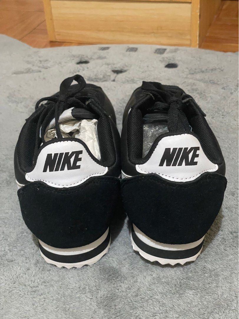 Nike Cortez Black and White Sneakers (Category: Sneakers) located in Cavite. Submitted by HelloAnn_Closet (Listing ID 1410079405, Image 3). Description: Classic Nike Cortez sneakers in black and white. Features the iconic Nike swoosh on the sides and the Nike logo on the heel. The shoes have a black upper with white soles. The soles show a zig-zag pattern. SIZE US 7.5 EU 38.5 Slim Fit.