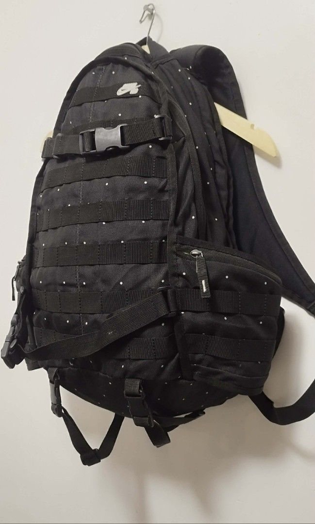Nike SB Backpack Black (Category: Backpacks) located in Manila. Submitted by esparciake75752 (Listing ID 1410082503, Image 2). Description: - Black Nike SB backpack with white polka dots - Multiple compartments for storage - Includes side pockets - Spacious main compartment with bright green interior - Adjustable straps for a comfortable fit - Secure buckle closure - Features Nike SB logo - Made of durable polyester material.