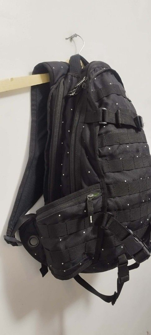 Nike SB Backpack Black (Category: Backpacks) located in Manila. Submitted by esparciake75752 (Listing ID 1410082503, Image 3). Description: - Black Nike SB backpack with white polka dots - Multiple compartments for storage - Includes side pockets - Spacious main compartment with bright green interior - Adjustable straps for a comfortable fit - Secure buckle closure - Features Nike SB logo - Made of durable polyester material.