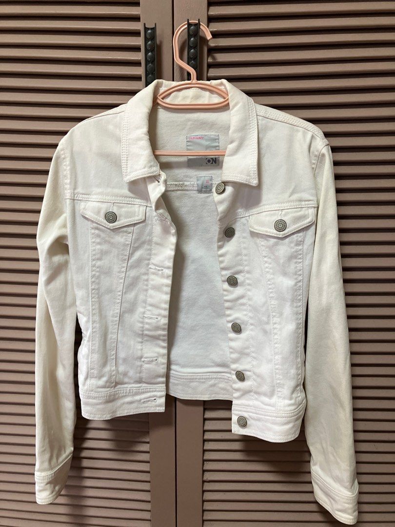 Old Navy White Denim Jacket XL (Category: Babies & Kids Fashion) located in Binan City. Submitted by mrsjca (Listing ID 1410043999, Image 1). Description: - Old Navy white denim jacket - Size: XL for pre teens - Classic design - Button closures - Pockets - Made in Cambodia - Versatile layering piece - slightly yellowed due to storage but can be restored with proper washing.