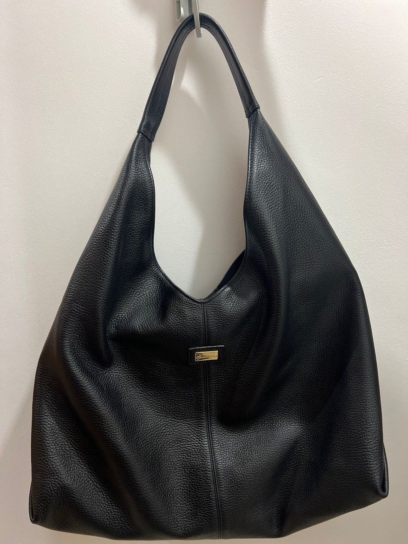 Russell & Bromley Everyday Oversized Shoulder Bag (Category: Shoulder Bags) located in Taguig. Submitted by ellejay8 (Listing ID 1409997310, Image 1). Description: - Russell & Bromley oversized shoulder bag - Large, slouchy design - Single shoulder strap - Includes dust bag - Gold-toned accent on the front - Made of a textured, leather-like material.