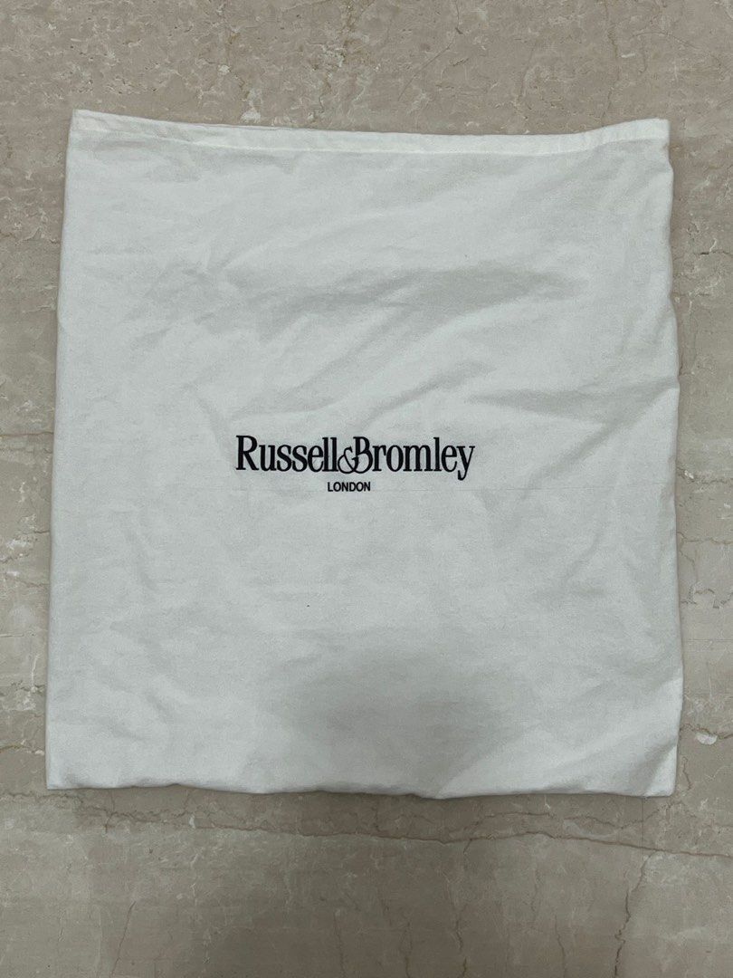 Russell & Bromley Everyday Oversized Shoulder Bag (Category: Shoulder Bags) located in Taguig. Submitted by ellejay8 (Listing ID 1409997310, Image 2). Description: - Russell & Bromley oversized shoulder bag - Large, slouchy design - Single shoulder strap - Includes dust bag - Gold-toned accent on the front - Made of a textured, leather-like material.