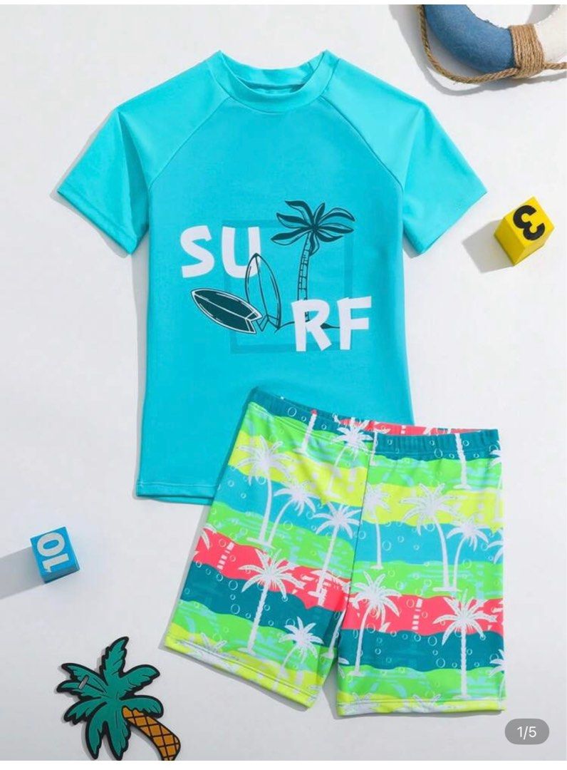 Shein Kids Surf Swimsuit Set (Category: Babies & Kids Fashion) located in Quezon City. Submitted by haylow (Listing ID 1410067629, Image 1). Description: - Kids' swimsuit set - Blue short-sleeved top with 'SURF' print and surfboard/palm tree graphic - Matching shorts with colorful striped pattern and palm trees - Ideal for beach or pool days.