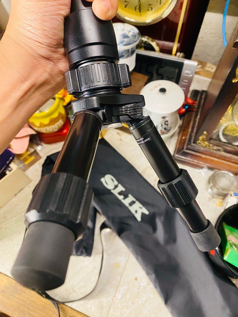 SLIK Monopod Stand (Category: Tripods & Monopods) located in Bacolod City. Submitted by jeffreyhue19895 (Listing ID 1410011047, Image 3). Description: - SLIK monopod with carrying case. - Stable three-leg base. - Adjustable height. - Ball head for flexible camera positioning. - SLIK logo visible..