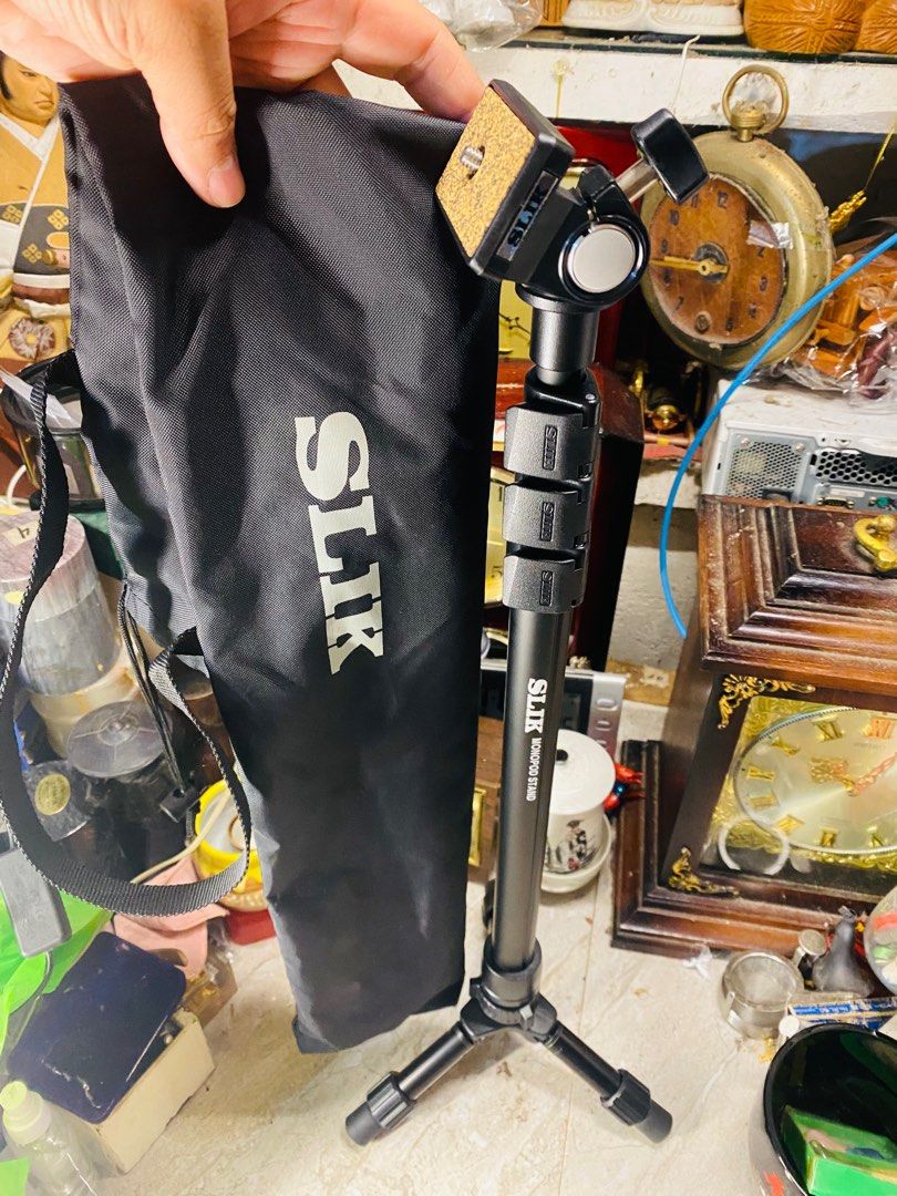 SLIK Monopod Stand (Category: Tripods & Monopods) located in Bacolod City. Submitted by jeffreyhue19895 (Listing ID 1410011047, Image 1). Description: - SLIK monopod with carrying case. - Stable three-leg base. - Adjustable height. - Ball head for flexible camera positioning. - SLIK logo visible..