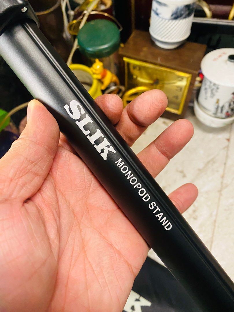 SLIK Monopod Stand (Category: Tripods & Monopods) located in Bacolod City. Submitted by jeffreyhue19895 (Listing ID 1410011047, Image 2). Description: - SLIK monopod with carrying case. - Stable three-leg base. - Adjustable height. - Ball head for flexible camera positioning. - SLIK logo visible..