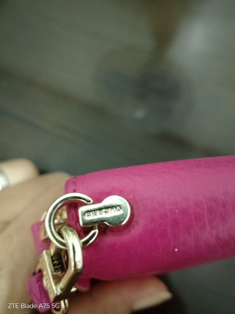Tucano Genuine Leather Wallet (Category: Wallets & Card holders) located in Manila. Submitted by _bueta.09 (Listing ID 1410035725, Image 3). Description: Genuine leather pink wallet with zip closure, wrist strap, and multiple compartments. Features Tucano logo..