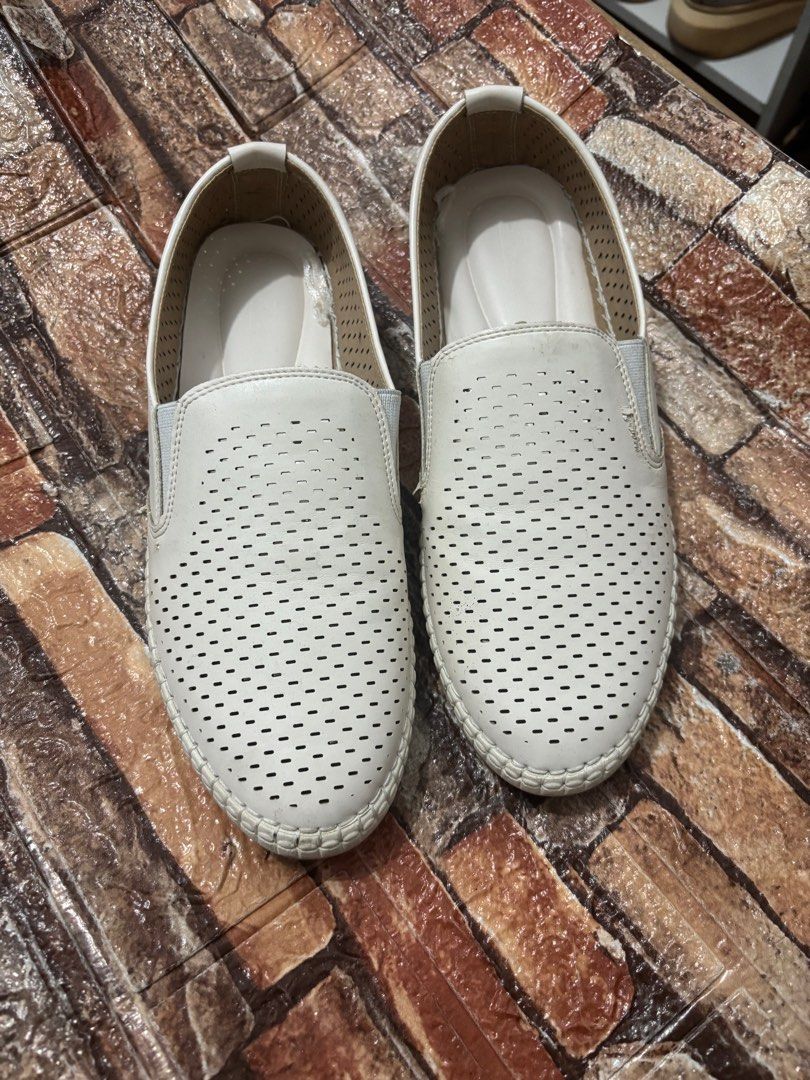 White Perforated Slip-on Shoes (Category: Flats & Sandals) located in Las Pinas. Submitted by ringringms (Listing ID 1410019153, Image 3). Description: - White slip-on shoes - Perforated design - Rounded toe - Textured insole - Smooth outer material - Simple, clean design - Light-colored soles - Comfortable for everyday wear - Worn once for a themed party - Size 11 on tag but fits size 8 .