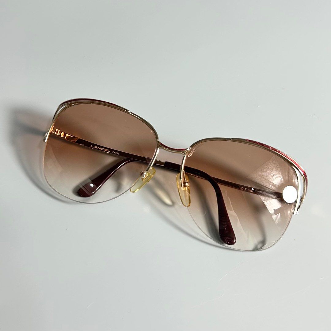 80s Vintage Lancel Paris Sunglasses (Category: Luxury Accessories) located in Cavite. Submitted by datsoretro (Listing ID 1410359329, Image 2). Description: - Lancel Paris sunglasses - Gold frame - Brown gradient lenses - Unique design with red accent - Replaceable lenses are a bit cracked -check last photo.