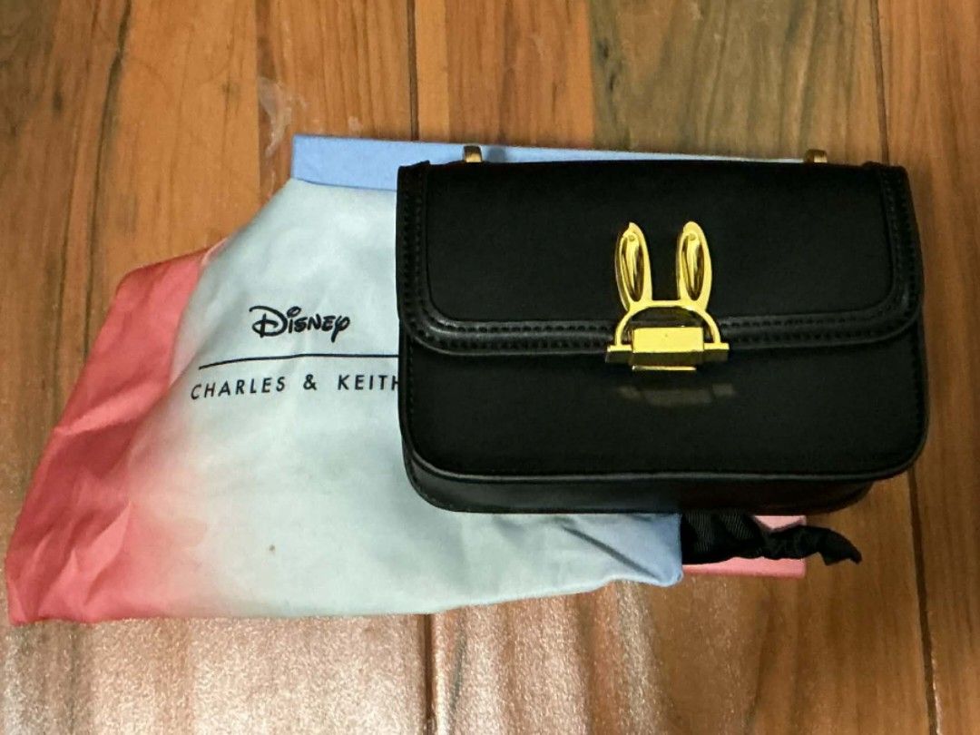 Disney Charles & Keith Bunny Bag (Category: Shoulder Bags) located in Alaminos. Submitted by declutteritems2024 (Listing ID 1410313841, Image 2). Description: rfs: decluttering SF is shouldered by the buyer origin: Alaminos, Pangasinan Delivery thru J&T Luzon: php 59.00 - Disney x Charles & Keith black handbag - Bunny ear clasp - Detachable chain with charms - Includes original box and dust bag - Interior zipper pocket - Used once .