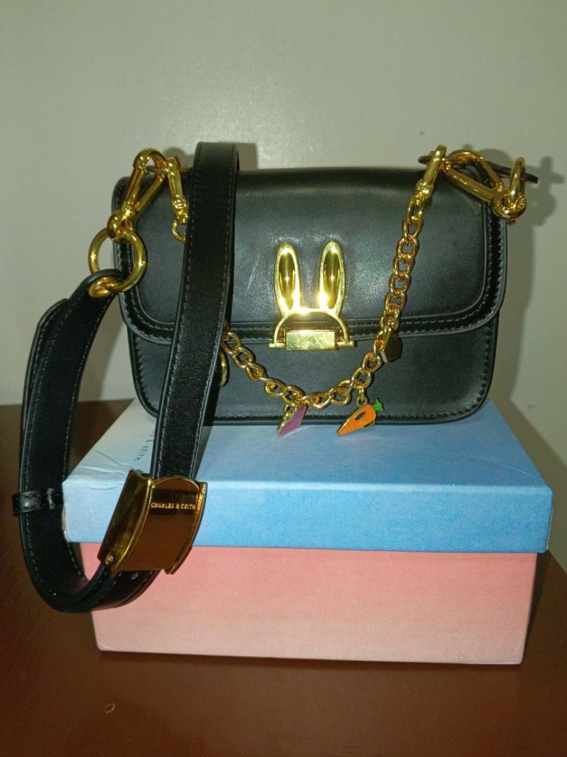 Disney Charles & Keith Bunny Bag (Category: Shoulder Bags) located in Alaminos. Submitted by declutteritems2024 (Listing ID 1410313841, Image 1). Description: rfs: decluttering SF is shouldered by the buyer origin: Alaminos, Pangasinan Delivery thru J&T Luzon: php 59.00 - Disney x Charles & Keith black handbag - Bunny ear clasp - Detachable chain with charms - Includes original box and dust bag - Interior zipper pocket - Used once .