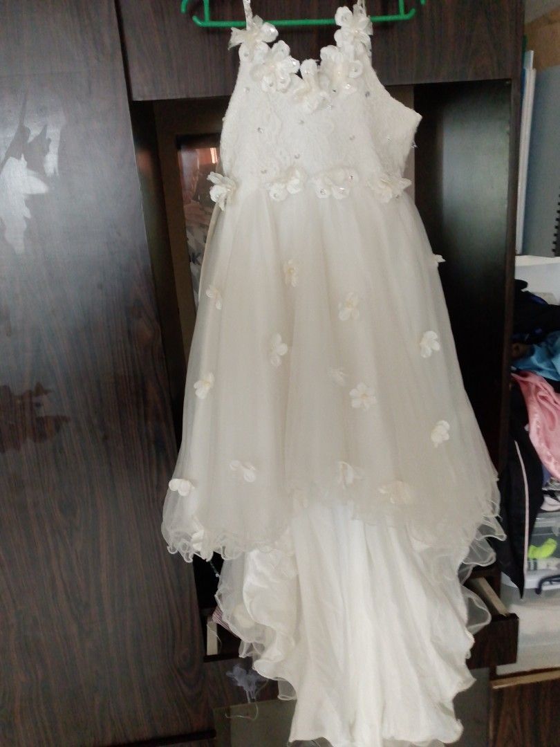 Elegant christmas dress (Category: Babies & Kids Fashion) located in Mandaluyong City. Submitted by ronald_1230 (Listing ID 1410211535, Image 2). Description: - White dress with floral details - Layered skirt design - Includes a train - Zipper closure at the back - Perfect for special occasions - Delicate floral accents on straps and bodice.