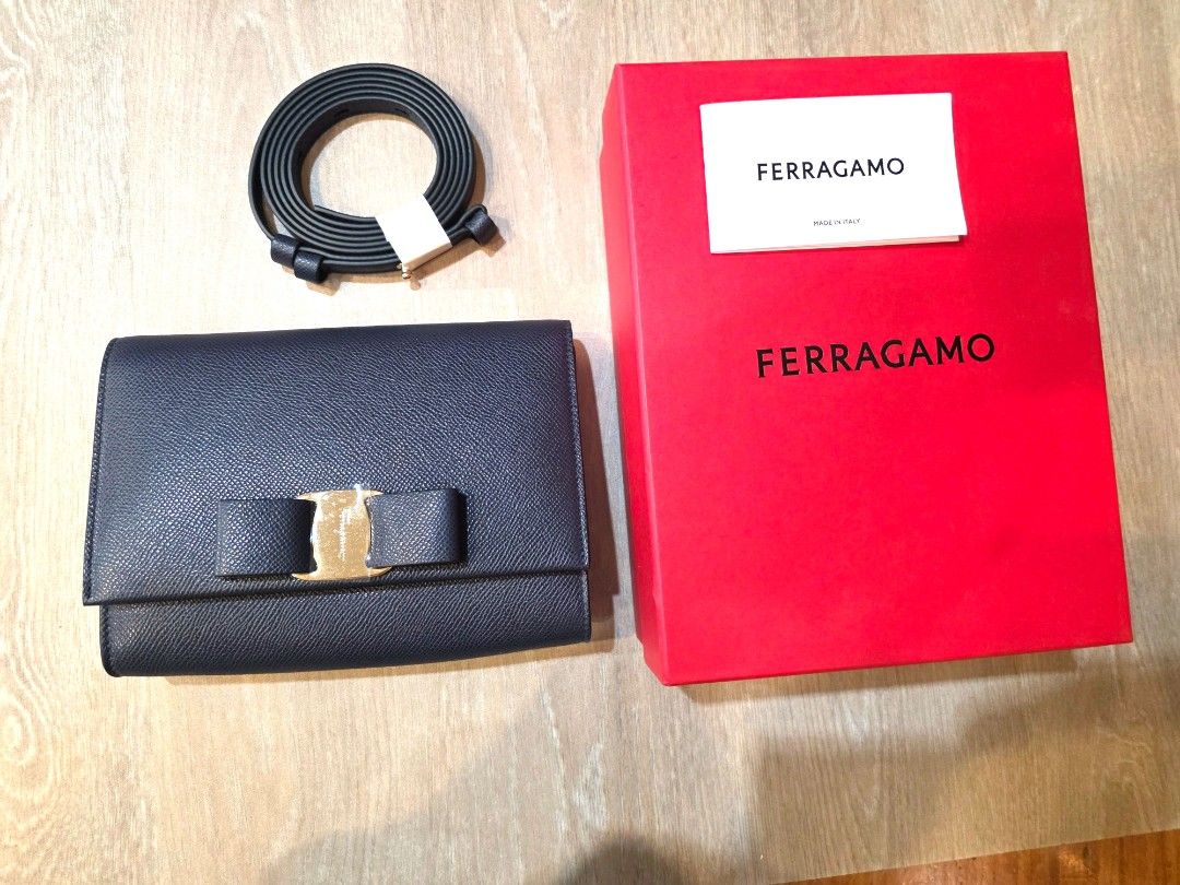 Ferragamo Vara Bow Clutch Navy Calf (Category: Luxury Bags & Wallets) located in Quezon City. Submitted by brandhub (Listing ID 1410211423, Image 1). Description: - Authentic Ferragamo Vara Bow Clutch - Navy grained calf leather - Includes original box and dust bag - Detachable strap included - Iconic Vara bow with gold-tone buckle.