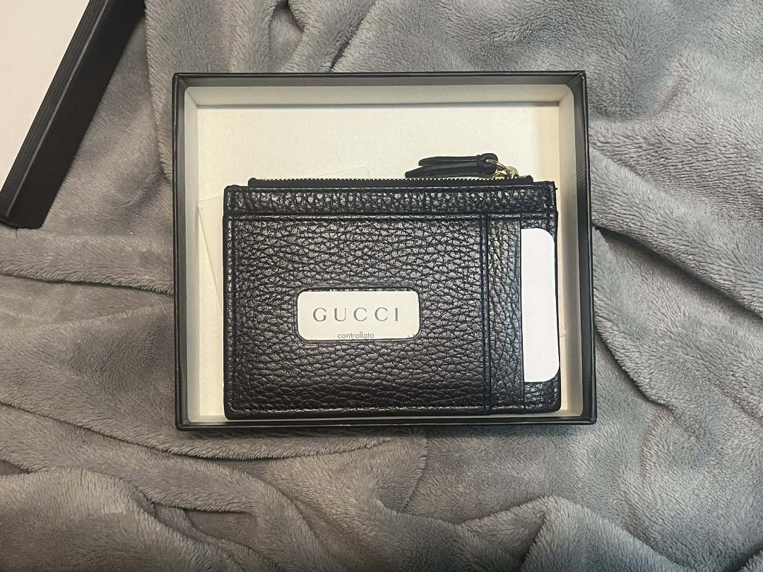 Gucci Card Case Wallet (Category: Luxury Bags & Wallets) located in Bacolor. Submitted by dizonjm21164367 (Listing ID 1410360616, Image 1). Description: - Authentic Gucci card case wallet - Black textured leather - Gold-tone GG logo - Zip closure - Multiple card slots - Interior zip pocket - Includes original box and dust bag.