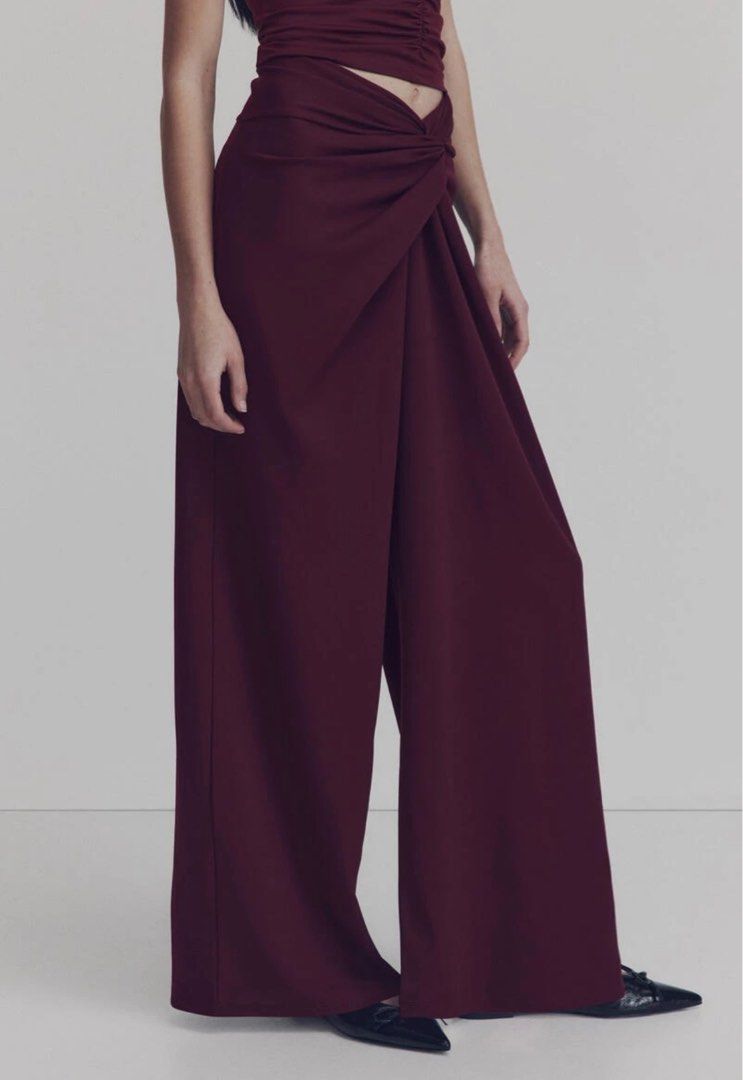 H&M Twisted-detail trousers (Category: Other Bottoms) located in Paranaque City. Submitted by vestured.ph (Listing ID 1410344814, Image 1). Description: Used once !!! :) - Fits M-L - Burgundy wide-leg pants - Unique knot detail at front waist - High-waisted - Relaxed, flowing fit - Smooth, woven fabric - Creates a chic and sophisticated look.