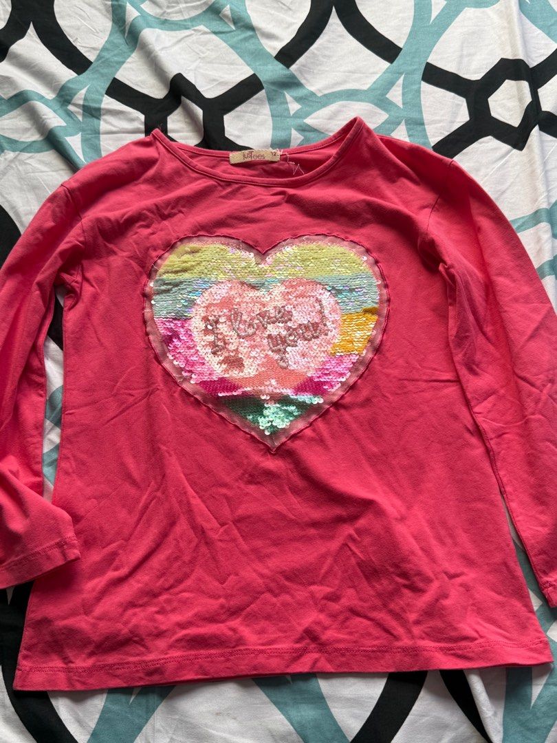 Just Tees Heart Sequin Long Sleeve Shirt (Category: Babies & Kids Fashion) located in Bacoor. Submitted by rizza_455 (Listing ID 1410192544, Image 1). Description: - Brand: Just Tees - Color: Pink - Design: Heart-shaped sequin with "I love you" text - Neckline: Round - Size: 12 fit to 5-7 yrs old.