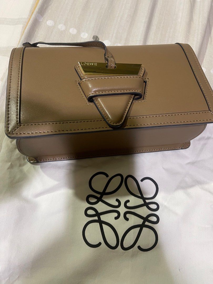 Loewe Puzzle Bag (Category: Luxury Bags & Wallets) located in Rizal. Submitted by catchyfinds (Listing ID 1410247558, Image 2). Description: - Loewe Bag - Taupe color - Top handle and detachable shoulder strap - Includes 2 straps - Flap closure with gold-tone metal detail - Includes dust bag and card - Multiple interior compartments.