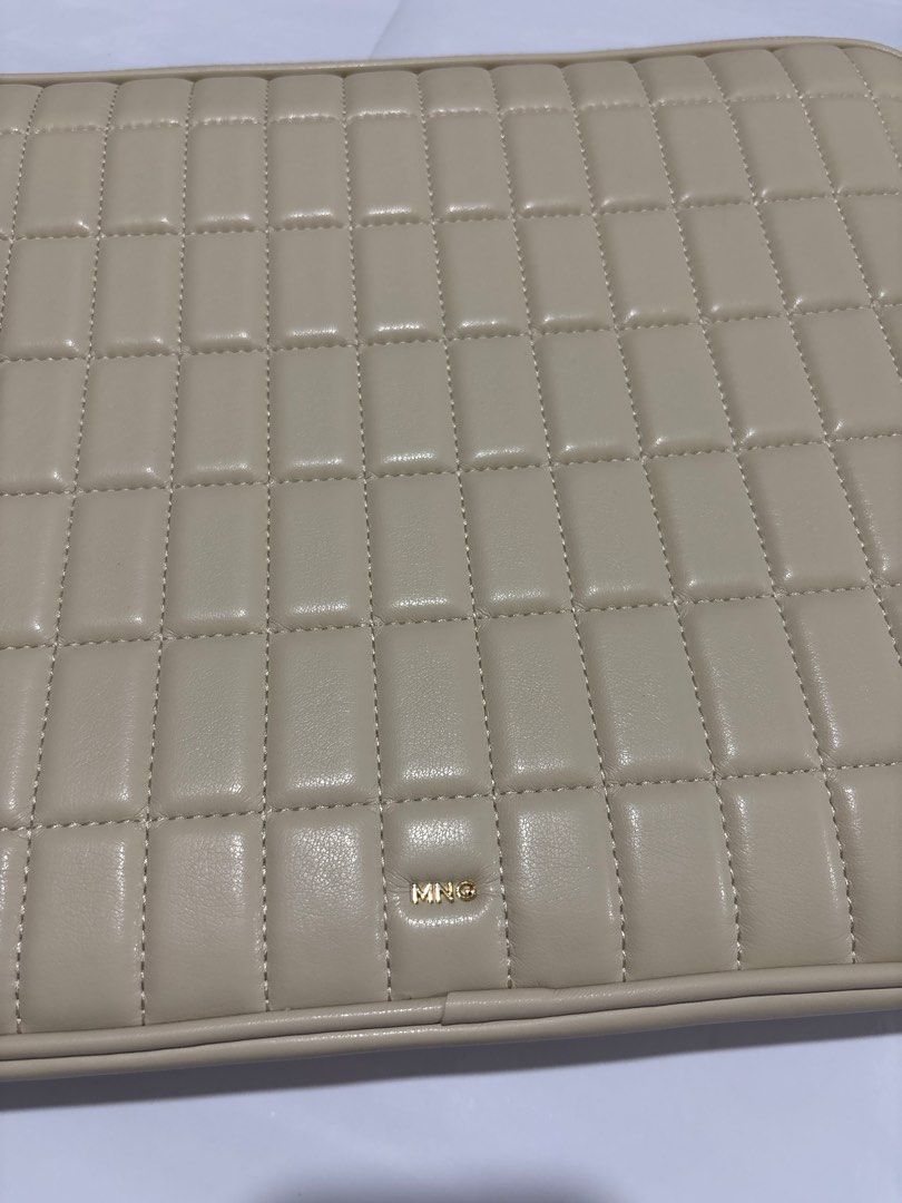 Mesa Quilted Laptop Sleeve (Category: Laptop Bags & Sleeves) located in Taguig. Submitted by passionfashion (Listing ID 1410291343, Image 2). Description: Cream-colored laptop sleeve with a quilted design. Features a gold-toned zipper and a small Mesa logo. The interior is a light beige color. Measures approximately 15 inches by 11 inches. Includes a small pocket inside..