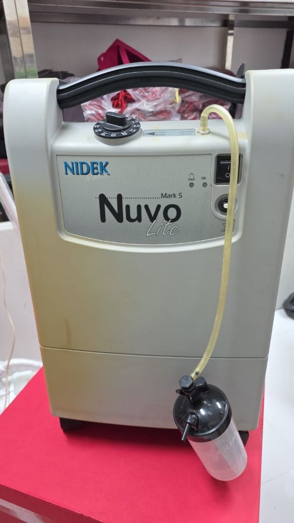 Nidek Nuvo Lite Model 920 STD Oxygen Concentrator (Category: Medical Supplies & Tools) located in Quezon City. Submitted by clezzyy (Listing ID 1410188328, Image 1). Description: - Nidek Nuvo Lite 920 STD Oxygen Concentrator - Power: 230V, 60Hz, 330W - Includes: Humidifier bottle and tubing - Portable design with handle and wheels - Features: Filter and power cord access on back panel.