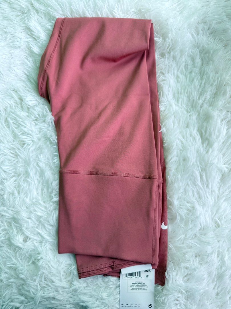 Nike Training Leggings - Dusty Rose - Size M (Category: Activewear) located in Manila. Submitted by luigeedeo (Listing ID 1410337971, Image 1). Description: - Nike training leggings - Dusty rose color - Size M - Nike swoosh logo - Mesh panel detail - Style code: DV9021-638 - Made in the Philippines.
