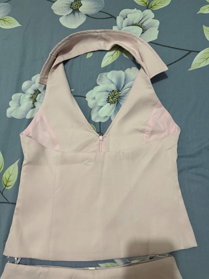 Pink Halter Top and Skort Set (Category: Sets or Coordinates) located in Valenzuela. Submitted by raquesells (Listing ID 1410346015, Image 3). Description: - Pink halter top with V-neck - Matching shorts with layered design - Top features a front zipper closure - Made of smooth, possibly satin-like fabric - Stylish outfit for various occasions -NEVER WORN.