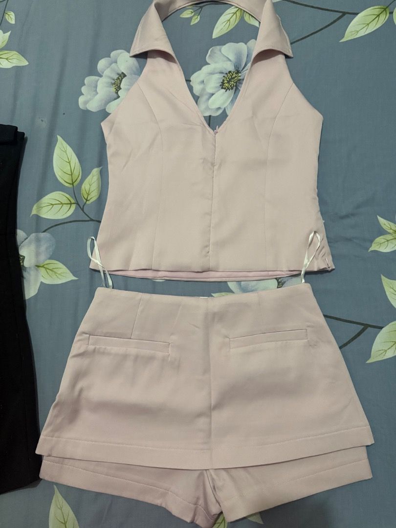 Pink Halter Top and Skort Set (Category: Sets or Coordinates) located in Valenzuela. Submitted by raquesells (Listing ID 1410346015, Image 2). Description: - Pink halter top with V-neck - Matching shorts with layered design - Top features a front zipper closure - Made of smooth, possibly satin-like fabric - Stylish outfit for various occasions -NEVER WORN.