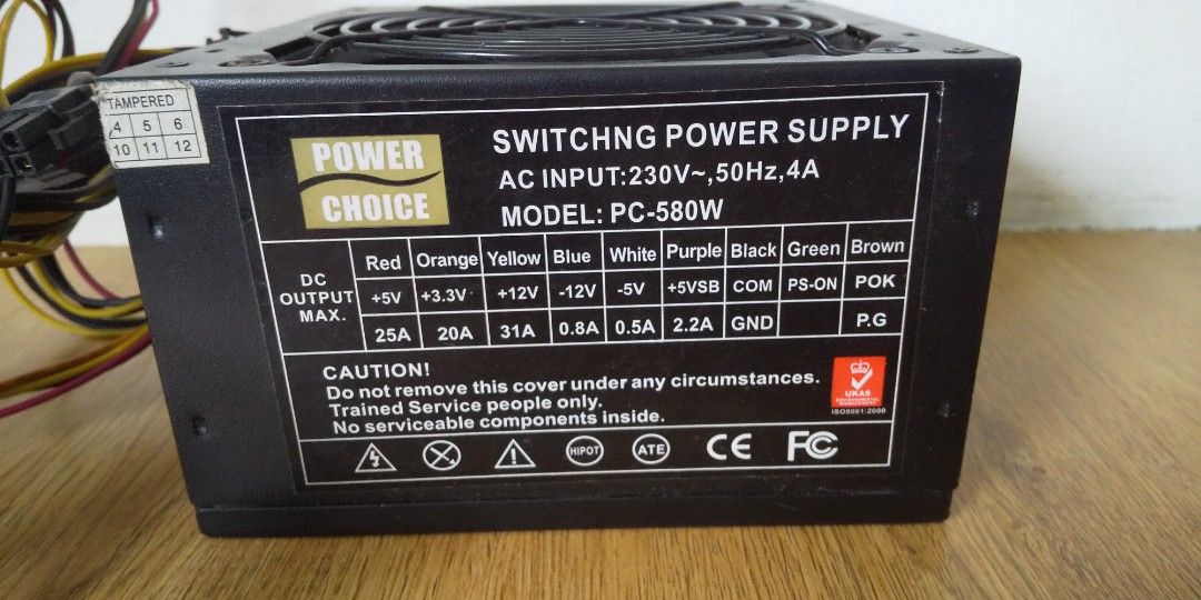 Power Choice PC-580W Switching Power Supply (Category: Computer Parts) located in Carmona. Submitted by rpute (Listing ID 1410190012, Image 3). Description: Power Choice PC-580W switching power supply. AC input: 230V, 50Hz, 4A. Includes various connectors. Features a fan for cooling. The back panel has an AC 230V sticker and a power switch. The unit has multiple output rails including +5V, +3.3V, -12V, and +5VSB..