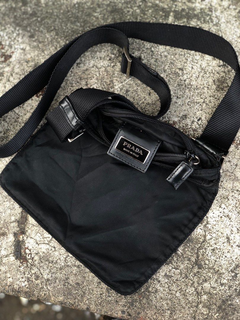 Prada Black Nylon Crossbody Bag (Category: Luxury Bags & Wallets) located in Bacolod City. Submitted by money_maker06 (Listing ID 1410216989, Image 3). Description: Prada Sling Bag 🌳 •Rare Size •Vintage •Authentic/Legit ✅ •Condition: Used/Good •Issue: Cracks,Peel off on leather and Just a normal sign of used 🖊 •Need restoration 🪵 •Price: 6999 💰 •Click each picture to appreciate the item 📸 •Dm me if you’re interested. I can give you more deta