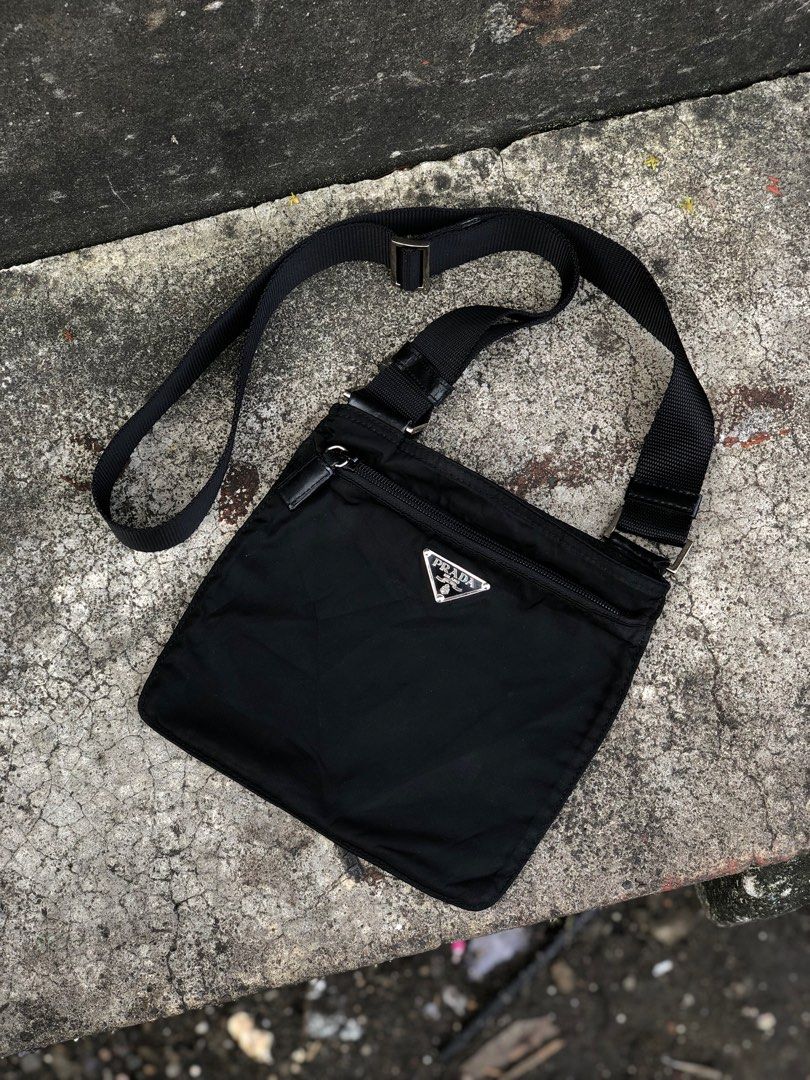 Prada Black Nylon Crossbody Bag (Category: Luxury Bags & Wallets) located in Bacolod City. Submitted by money_maker06 (Listing ID 1410216989, Image 1). Description: Prada Sling Bag 🌳 •Rare Size •Vintage •Authentic/Legit ✅ •Condition: Used/Good •Issue: Cracks,Peel off on leather and Just a normal sign of used 🖊 •Need restoration 🪵 •Price: 6999 💰 •Click each picture to appreciate the item 📸 •Dm me if you’re interested. I can give you more deta