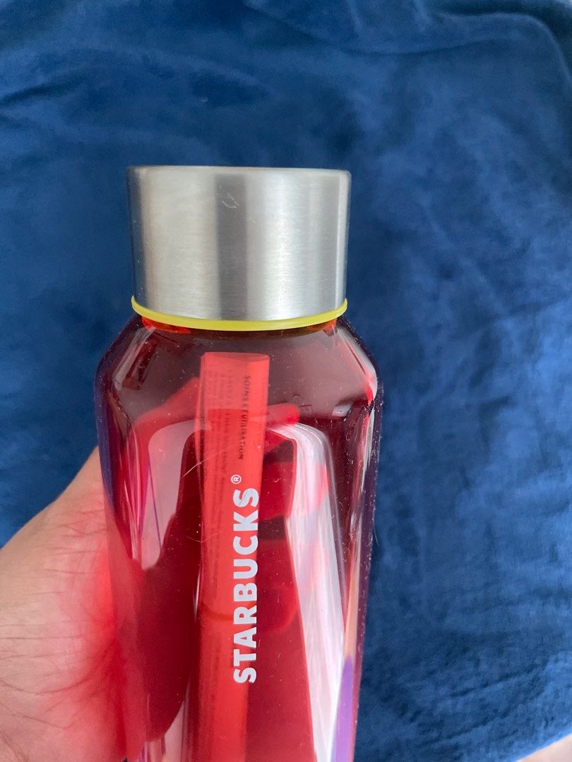 Starbucks Water Bottle 20oz (Category: Water Bottles & Tumblers) located in Taguig. Submitted by fae99 (Listing ID 1410231736, Image 1). Description: - Brand New, never used - Purchased in US $22.95 - Starbucks water bottle features a red gradient design. It has a silver cap with a yellow ring and a clear body. The bottle includes a paper insert. The bottom of the bottle has a sticker with the Starbucks logo and product information. It is made in