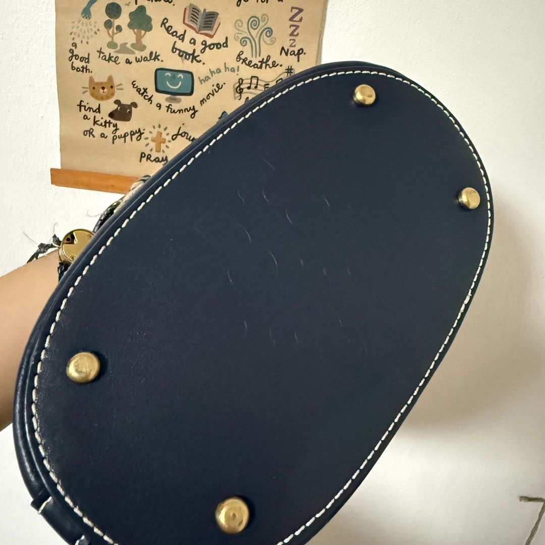 Tory Burch Monogram Jacquard Mini Bucket Bag (Category: Luxury Bags & Wallets) located in Bacoor. Submitted by pausroom (Listing ID 1410336546, Image 3). Description: - Tory Burch bucket bag - Navy and beige pattern - Drawstring closure - Leather base and trim - Detachable shoulder strap - Yellow interior - Gold-tone logo and hardware - Small pocket on the back - LP posted - Orig price 1500 Only flaw is the string not guaranteed auth RFS: declutt