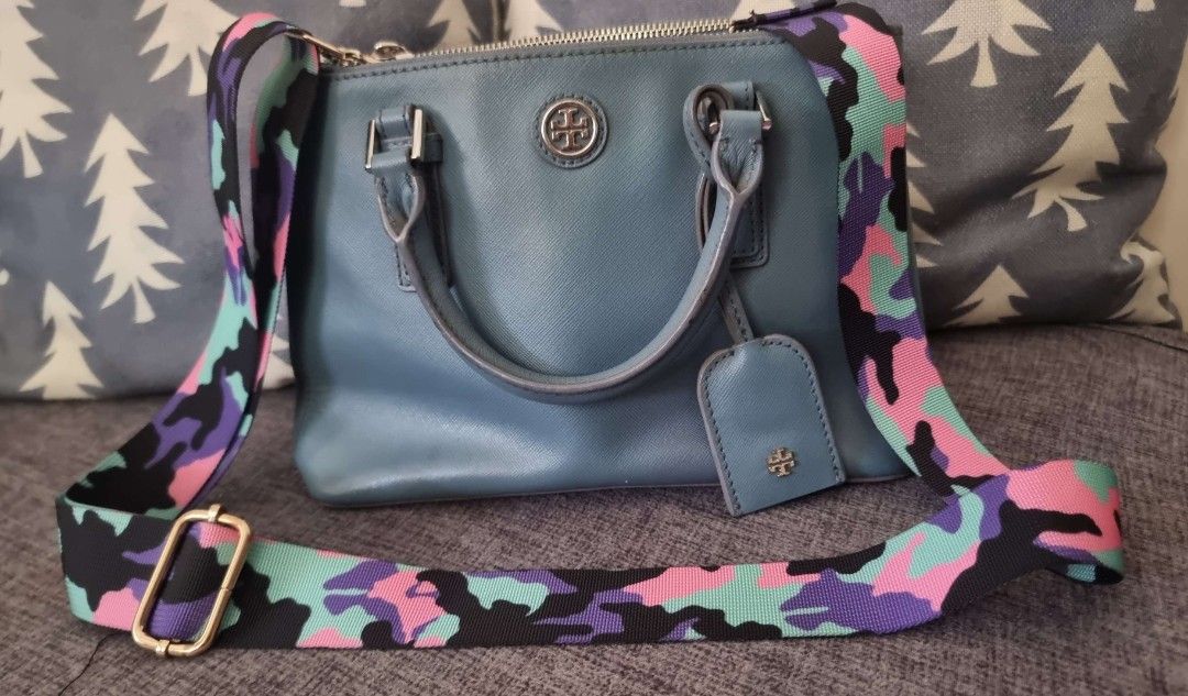 Tory Burch Satchel Handbag orig with Strap (Category: Luxury Bags & Wallets) located in Tarlac. Submitted by ichiban03 (Listing ID 1410308812, Image 2). Description: Negotiable Pre Love Blue Tory Burch satchel handbag. Features a top handle and free detachable strap with a colorful pattern dont have the original strap . Includes a matching leather tag. The bag has a double zipper closure..
