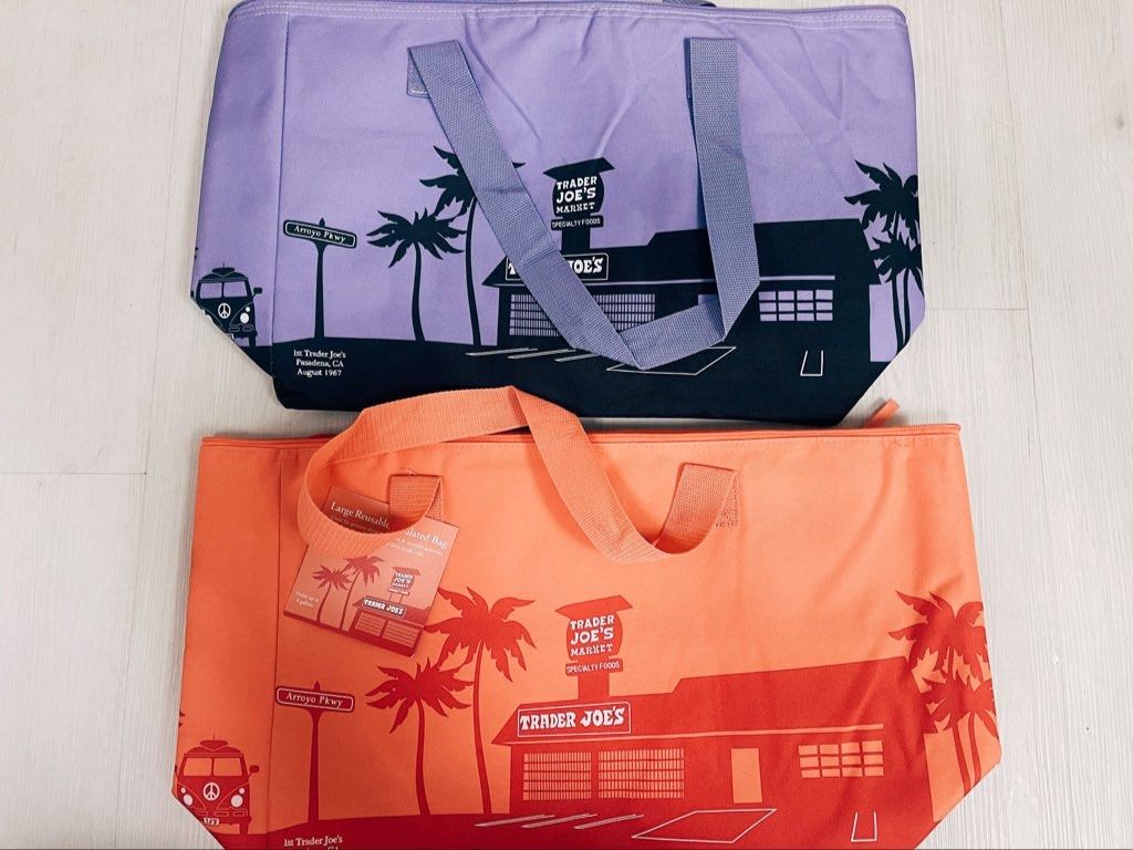 Trader Joe's Large Insulated Reusable Bag (Category: Tote Bags) located in Taguig. Submitted by beanutputter00 (Listing ID 1410200919, Image 1). Description: - Trader Joe's insulated reusable bag. - Features a unique design. - Includes a zipper closure. - Has handles for easy carrying. - Ideal for groceries and other items. - Available in two colors: purple and peach.