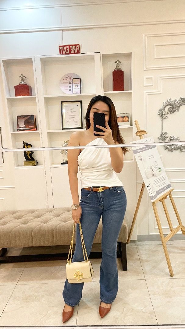White One-Shoulder Top (Category: Sleeveless) located in Pasig City. Submitted by alwaysfaevored (Listing ID 1410353725, Image 2). Description: - Elegant white one-shoulder top - Features a stylish draped design - Versatile for various occasions - Easy to pair with jeans or trousers - A chic addition to your wardrobe.