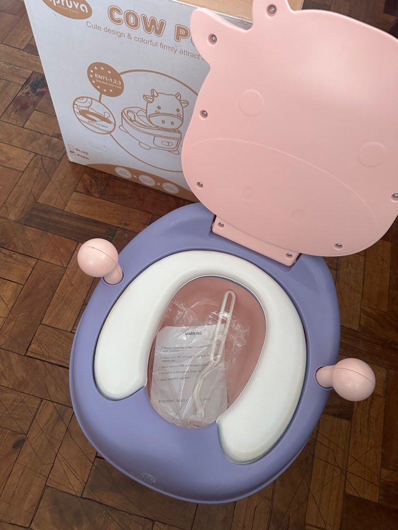 Apruva Cow Potty Trainer (Category: Toilet Training) located in Naga. Submitted by shifttothrift.joy (Listing ID 1410416852, Image 2). Description: Apruva Potty Trainer Purple-Pink Cow Design Brand new; just opened but unused Complete with box and accessories Reason for Selling: we opted to use toilet seat for our kid’s potty training Pick up from 📍Fluff & Fold Laundry Shop 68 MT Villanueva Ave. Liboton Naga City Camarines Sur (beside Aquabest).