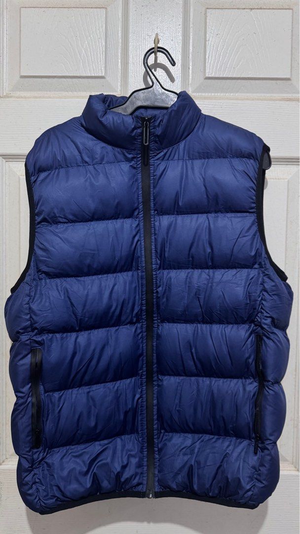 Blue Puffer Vest (Category: Vests) located in Quezon City. Submitted by chamibee (Listing ID 1410469335, Image 1). Description: - Blue puffer vest - Full-zip closure - Two side pockets - Stand-up collar - Quilted design - Lightly insulated - Solid blue color with black trim.