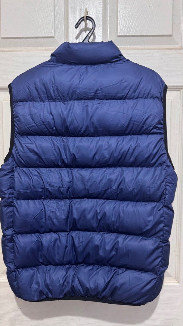 Blue Puffer Vest (Category: Vests) located in Quezon City. Submitted by chamibee (Listing ID 1410469335, Image 2). Description: - Blue puffer vest - Full-zip closure - Two side pockets - Stand-up collar - Quilted design - Lightly insulated - Solid blue color with black trim.