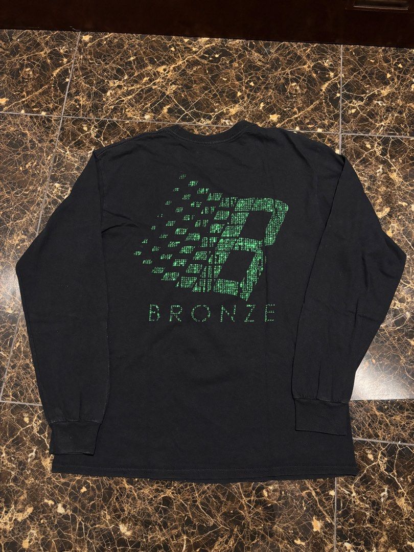 Bronze Long Sleeve Shirt (Category: Tshirts & Polo Shirts ) located in Pasig City. Submitted by functionalrags (Listing ID 1410514574, Image 1). Description: - Black long sleeve shirt - Features a green and white Bronze logo on the back and a smaller logo on the front - Crew neck design - Size: Medium - Bronze logo printed on the inside collar.