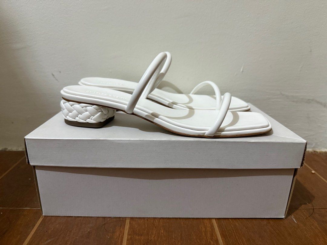 Charles & Keith Double-Strap Braided-Heel Mules - White (Category: Heels) located in Muntinlupa City. Submitted by anneyways (Listing ID 1410420513, Image 2). Description: - Charles & Keith mules - White color - Size 39 - Double-strap design - Braided heel detail - Open toe - Comes with original box - Style code: CK1-60051036 Bought in Singapore. Never used..