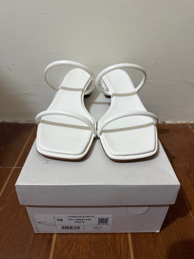 Charles & Keith Double-Strap Braided-Heel Mules - White (Category: Heels) located in Muntinlupa City. Submitted by anneyways (Listing ID 1410420513, Image 1). Description: - Charles & Keith mules - White color - Size 39 - Double-strap design - Braided heel detail - Open toe - Comes with original box - Style code: CK1-60051036 Bought in Singapore. Never used..
