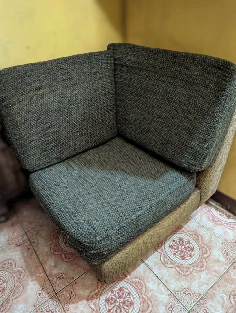 Corner Sofa (Category: Sofas) located in Marikina City. Submitted by beybera (Listing ID 1410401354, Image 3). Description: - Two-tone design: Gray seat/back, tan base. - Angular, space-saving shape. - Compact size, ideal for small living areas. - Well-constructed for comfortable seating. - Perfect as an accent piece. More details: never actually got to use this corner sofa. I admit I don't want to let go since it's REALLY NICE. pero no space na 