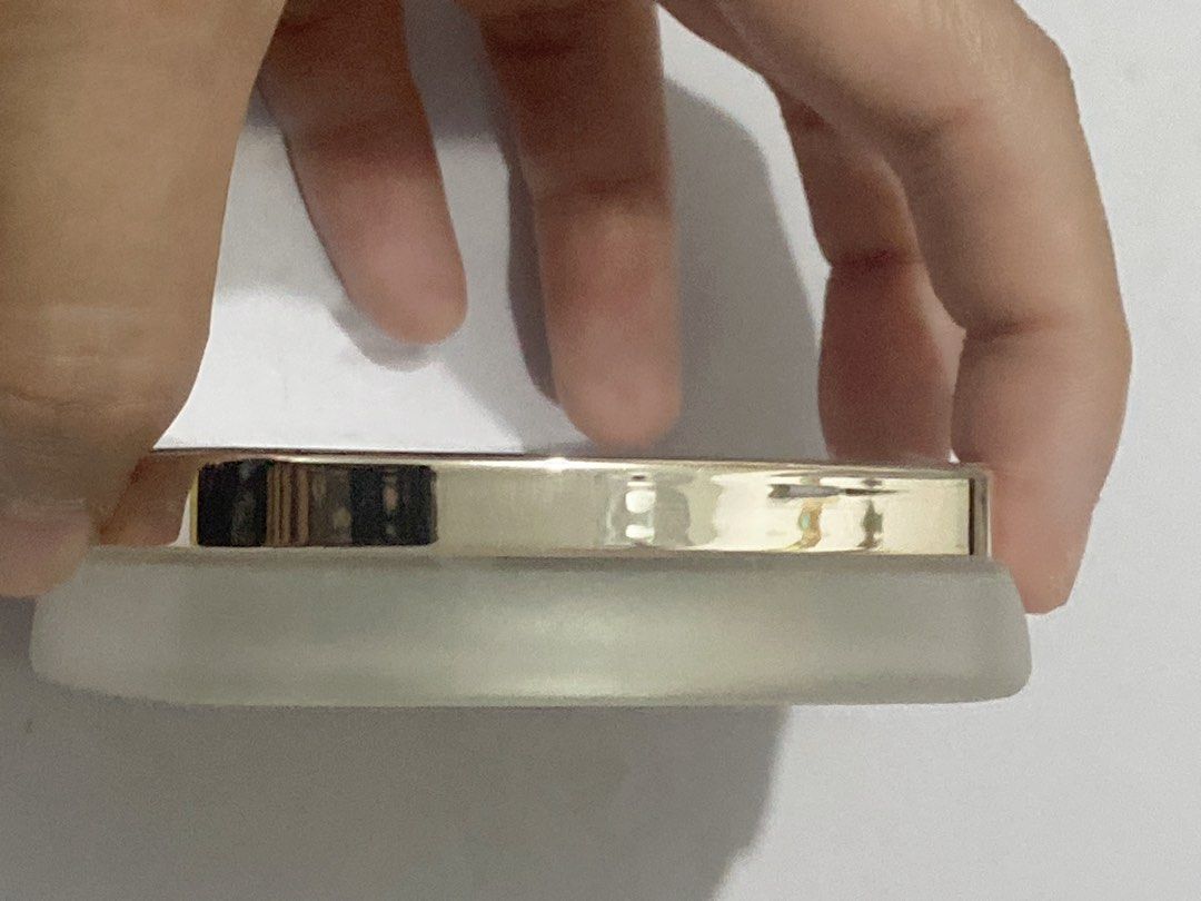 La Mer The Powder (Category: Makeup) located in Del Monte. Submitted by pageturner_digital (Listing ID 1410484457, Image 3). Description: - La Mer The Powder compact. - Silver top with La Mer logo. - Light beige powder color. - Gold-colored rim. - Square-shaped with rounded corners. - Brand new in original packaging. .