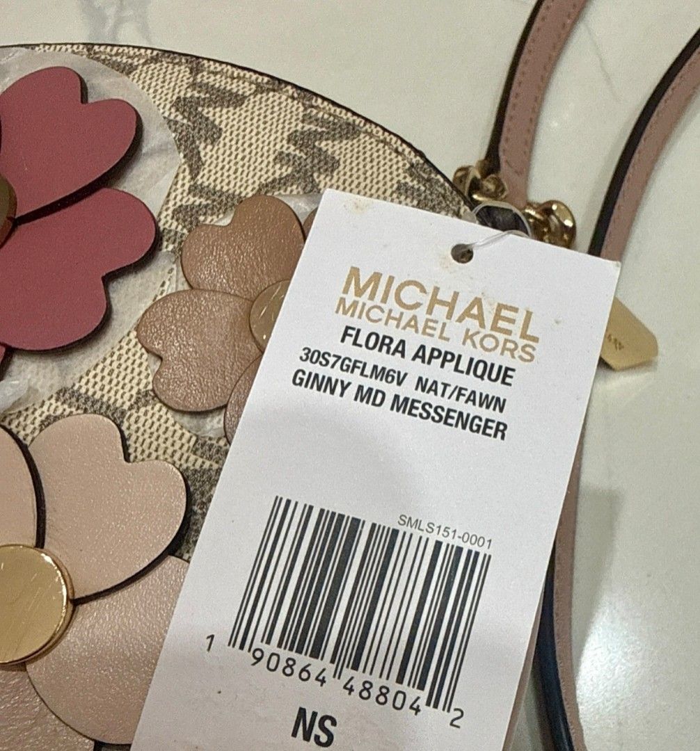 Michael Kors Flora Applique Ginny Medium Messenger bag (Category: Luxury Bags & Wallets) located in Dasmarinas. Submitted by bzbeezcar0u5el1 (Listing ID 1410399901, Image 2). Description: The Michael Kors “Flora Applique Ginny Medium Messenger” bag - never been used (due to personal preference) - has card slots inside - fits an iphone pro max - minor deformities on the bag and leather Bag Size (approximate): • Width: ~8 ½ inches (about 21.5 cm) •