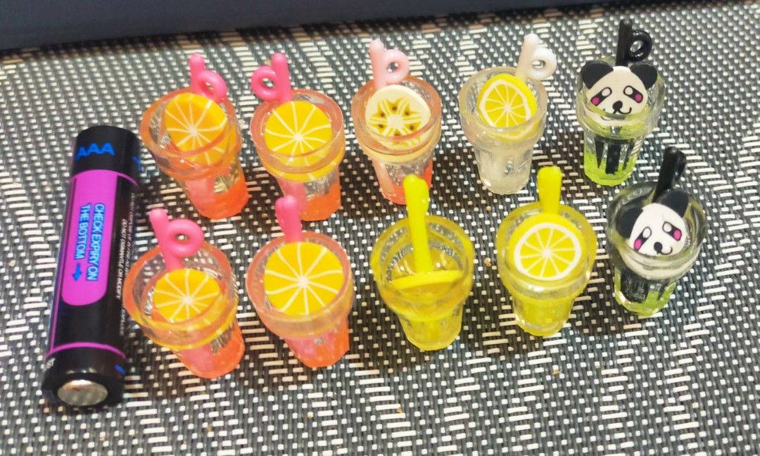Miniature Drink and Ice Cream Charms (Category: Charms) located in Dipolog. Submitted by queenibee01 (Listing ID 1410379914, Image 1). Description: Adorable miniature charms featuring drink and ice cream designs. The drink charms include lemon slices and panda designs. The ice cream charms come in pink and chocolate colors. These charms are perfect for crafting or adding a cute touch to your accessories..